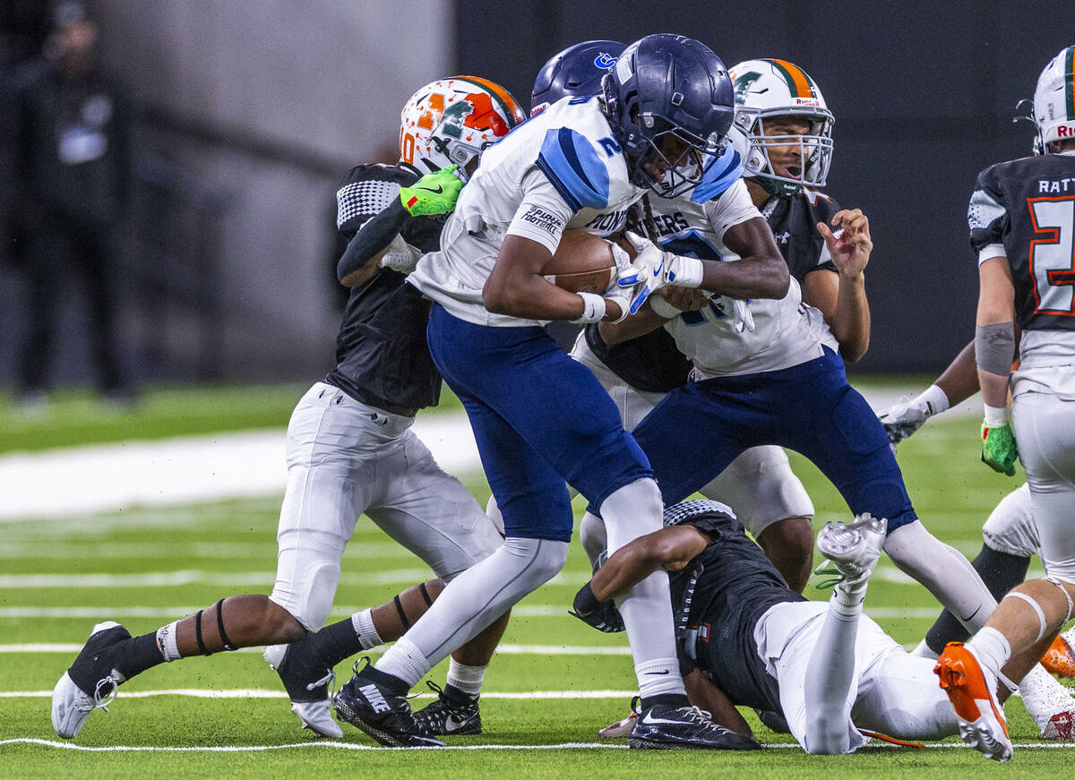 Canyon Springs wide receiver Major Pride (2) is tackled by Mojave safety D'terrion Bowman (10) ...