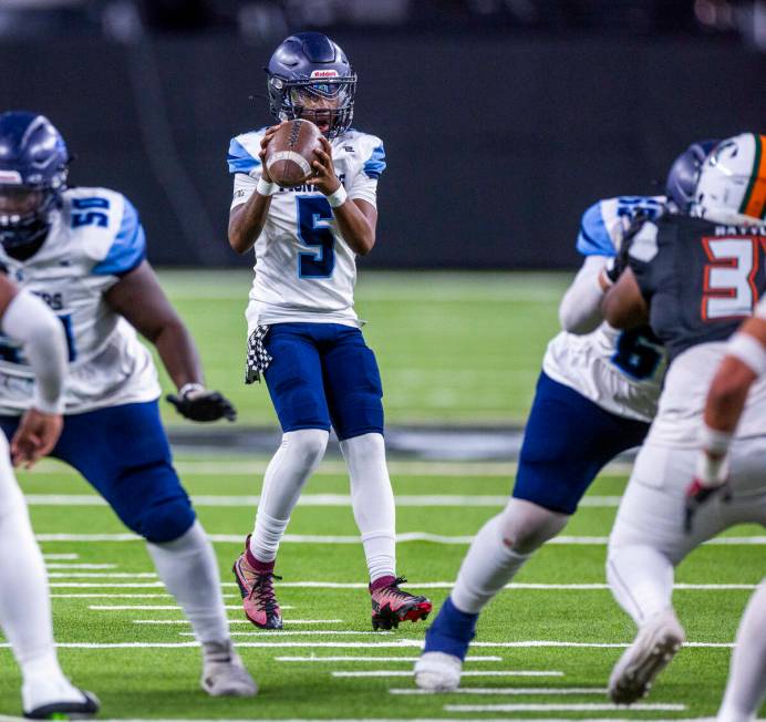 Canyon Springs quarterback Tysean McCraney (5) takes a snap against Mojave during the first hal ...