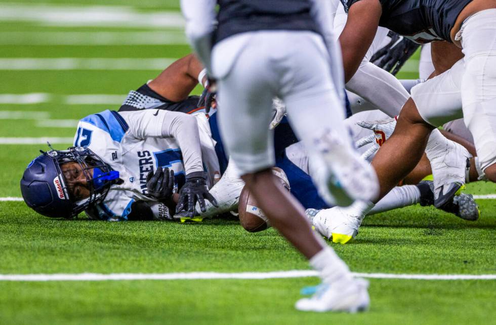 Canyon Springs running back Bakari Wilson (21) fumbles the ball against Mojave during the first ...