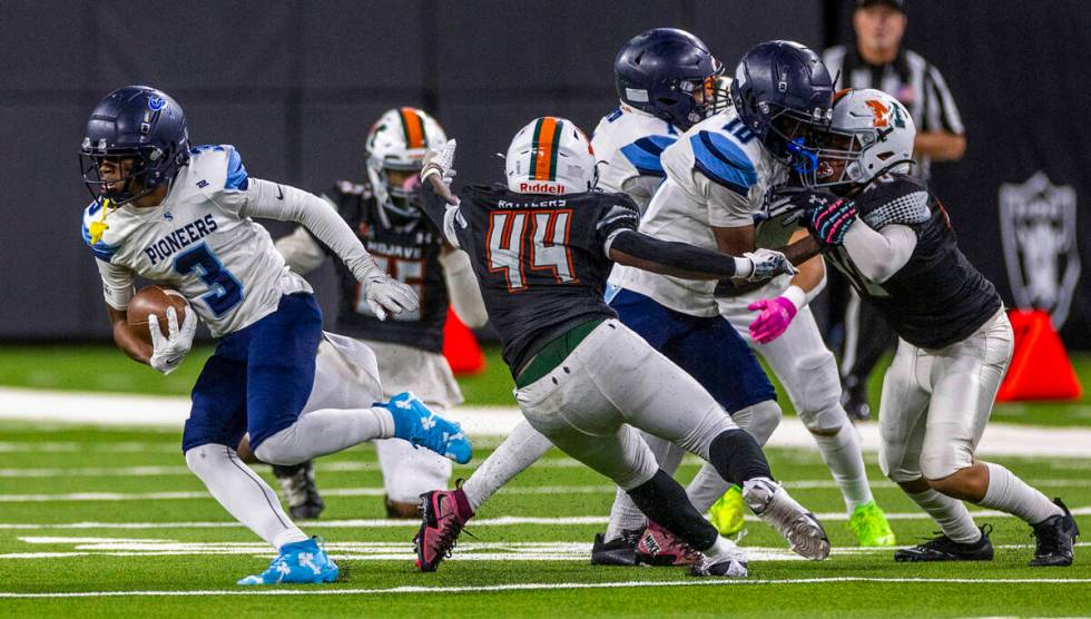 Canyon Springs running back Amere Swan (3) escapes a tackle by Mojave linebacker Zechariah John ...