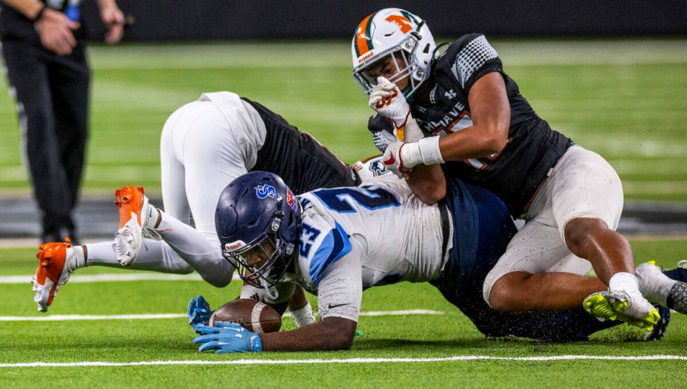 Canyon Springs middle linebacker Mychal Johnson (23) recovers a fumble against Mojave during th ...