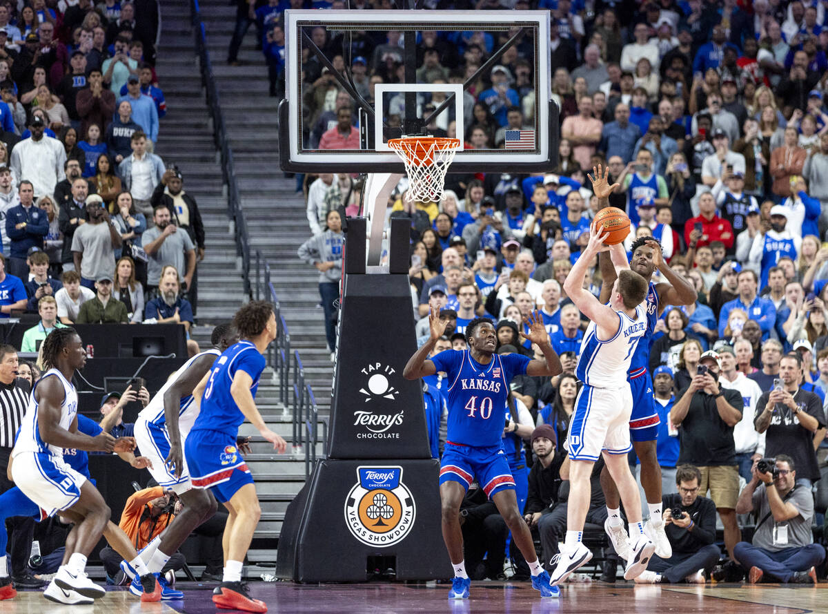 Kansas Jayhawks forward KJ Adams Jr., back, blocks a shot by Duke Blue Devils guard Kon Knueppe ...