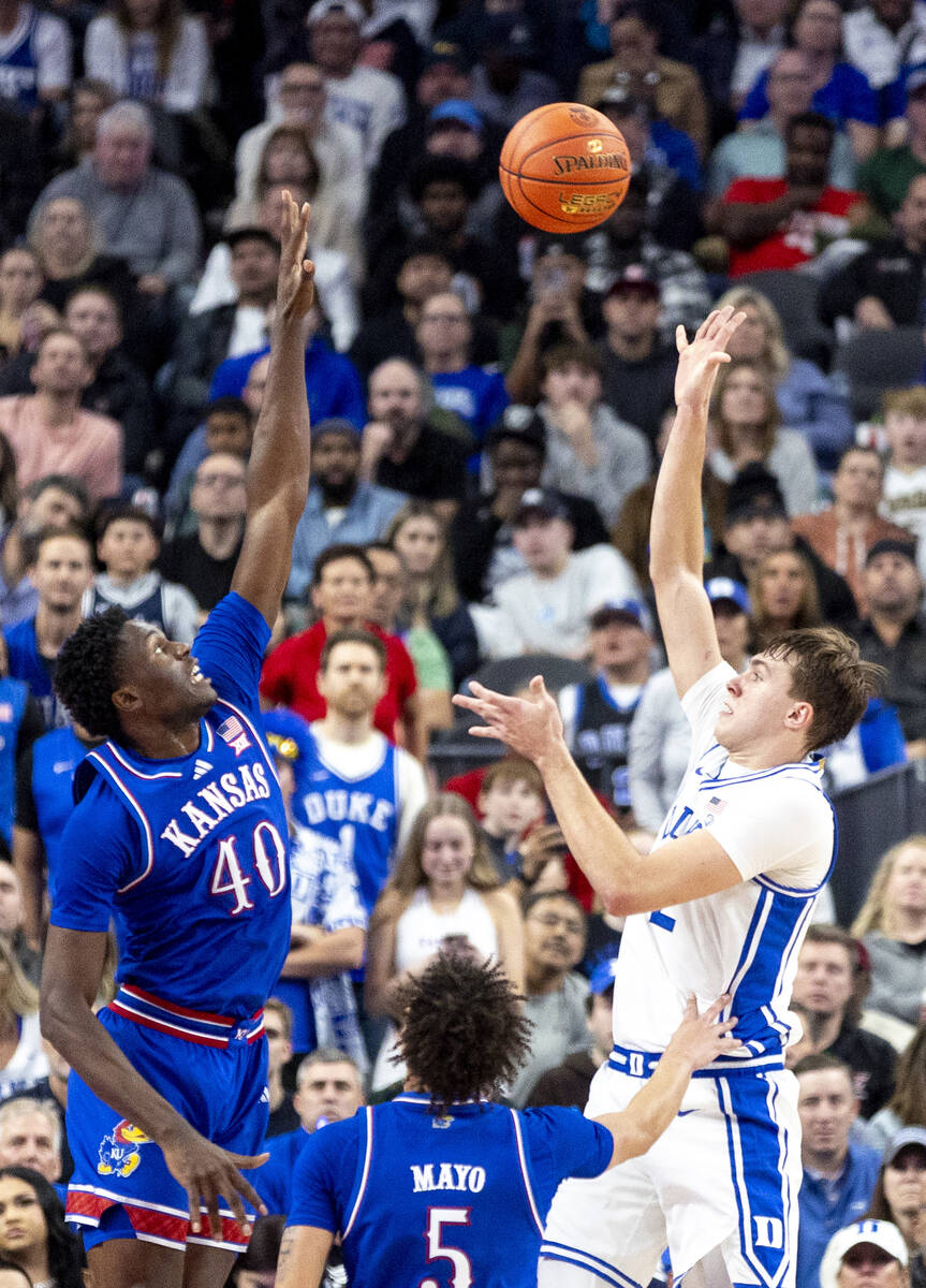 Duke Blue Devils guard Cooper Flagg, right, attempts a shot over Kansas Jayhawks forward Flory ...