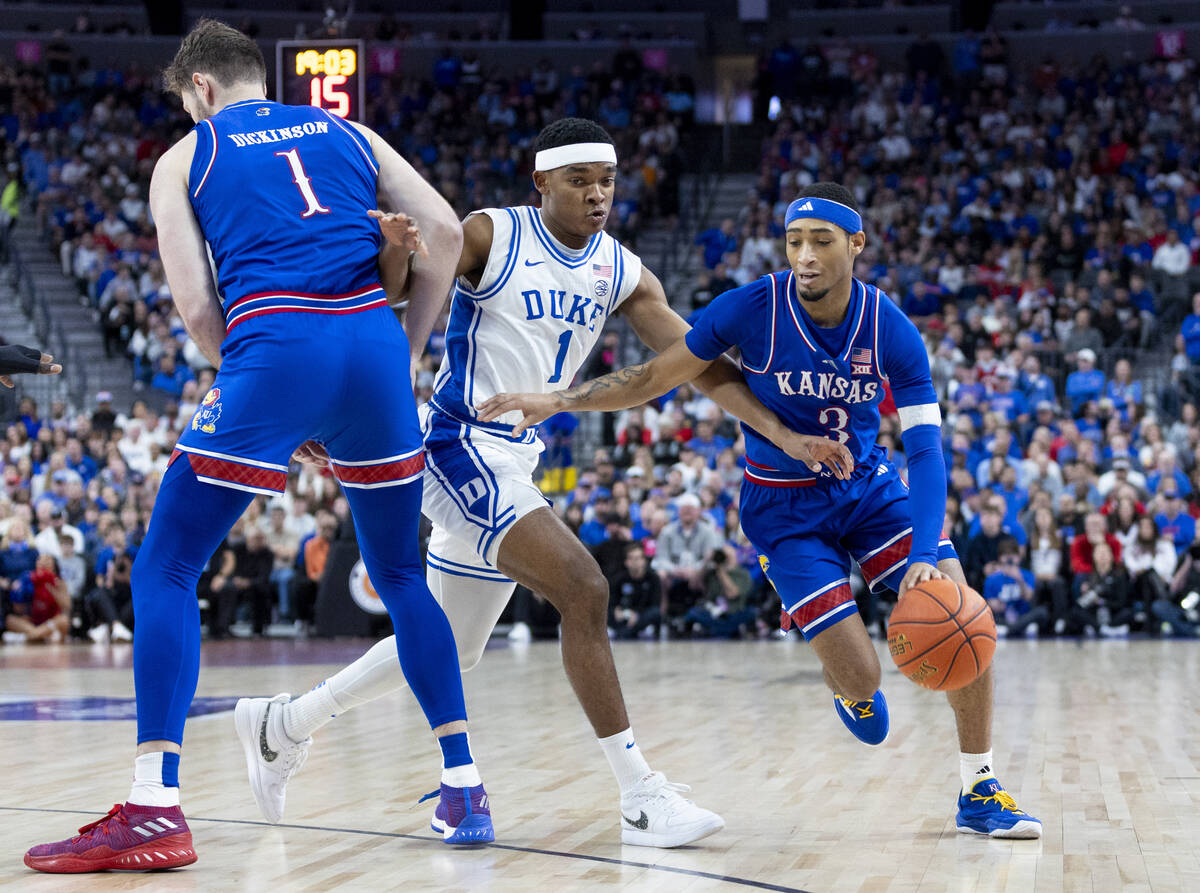 Kansas Jayhawks guard Dajuan Harris Jr. (3) attempts to pass Duke Blue Devils guard Caleb Foste ...