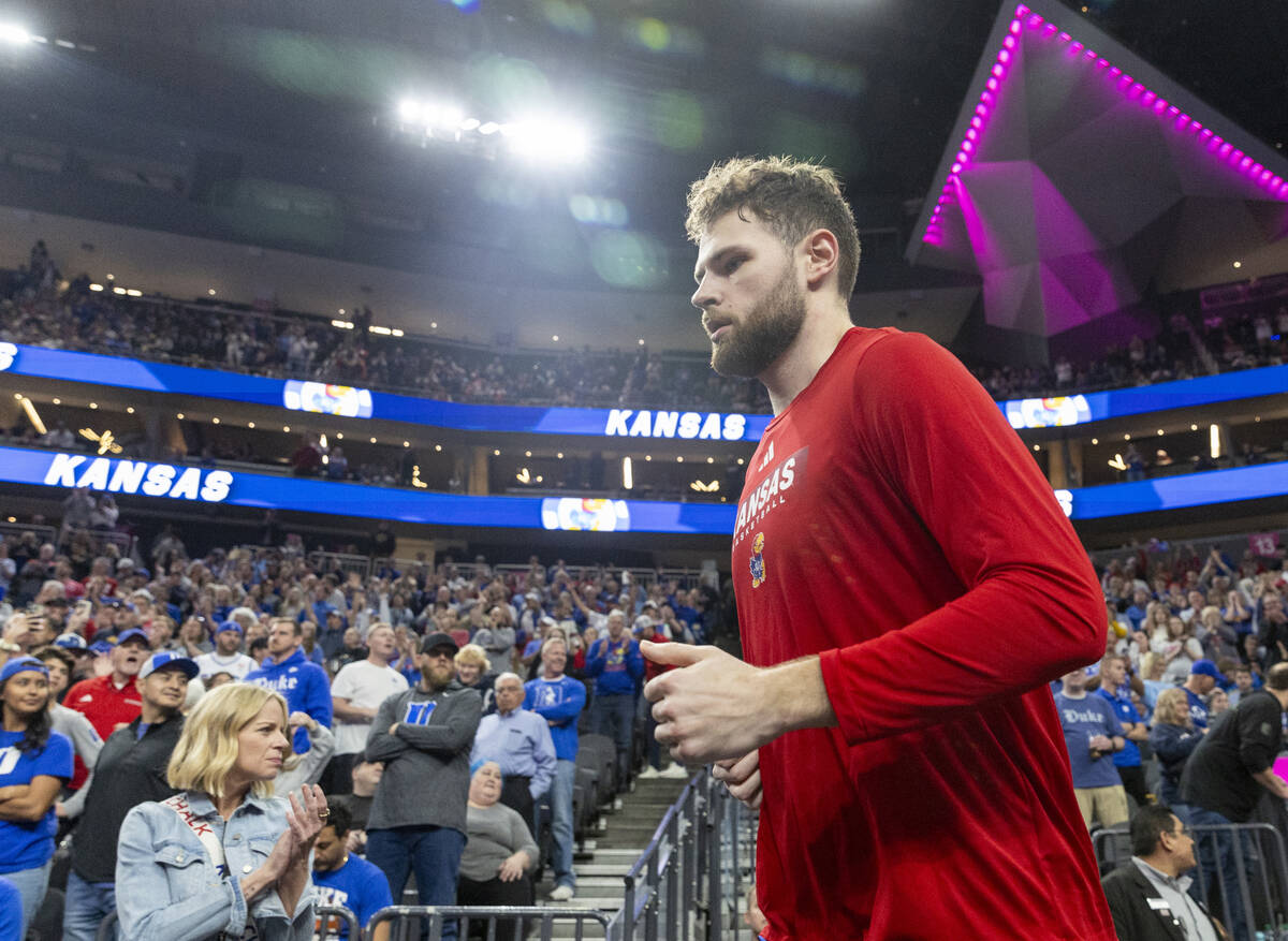 Kansas Jayhawks center Hunter Dickinson runs out of the tunnel before the Vegas Showdown colleg ...