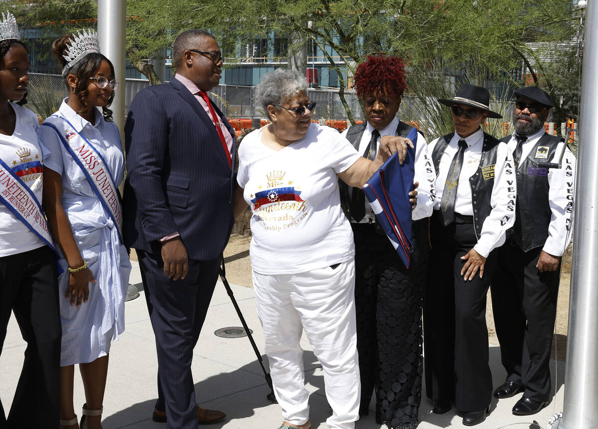 Dee Evans, president of National Juneteenth Observance Foundation of Nevada, center, presents t ...