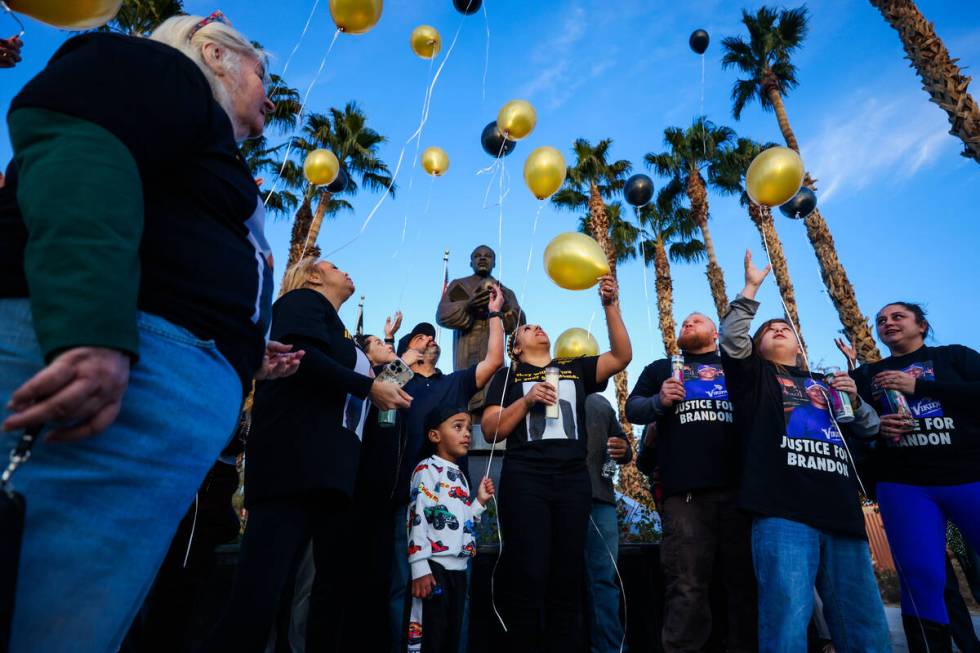 Family and friends release balloons during a vigil for Brandon Durham, who was shot and killed ...