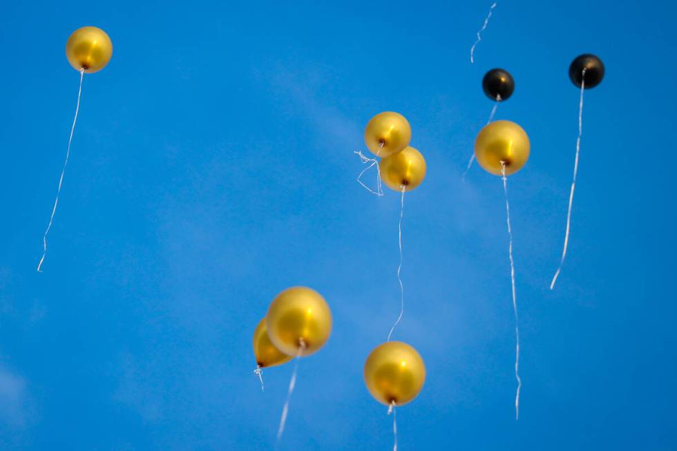 Balloons are released into the sky during a vigil for Brandon Durham, who was shot and killed i ...