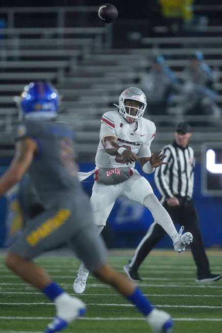 UNLV quarterback Hajj-Malik Williams, right, passes during the second half of an NCAA college f ...