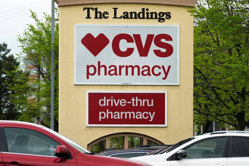 CVS pharmacy and drive-thru signs are seen outside of a CVS store in Park Ridge, Ill., April 29 ...