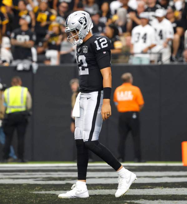 Raiders quarterback Aidan O'Connell (12) looks down after being sacked by Pittsburgh Steelers d ...