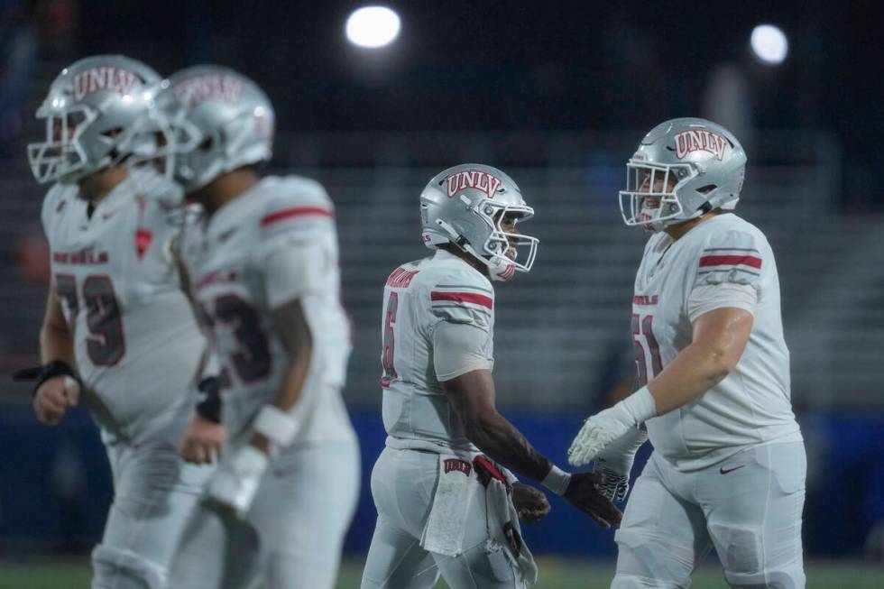 UNLV quarterback Hajj-Malik Williams (6) celebrates with offensive lineman Mason Vicari, right, ...