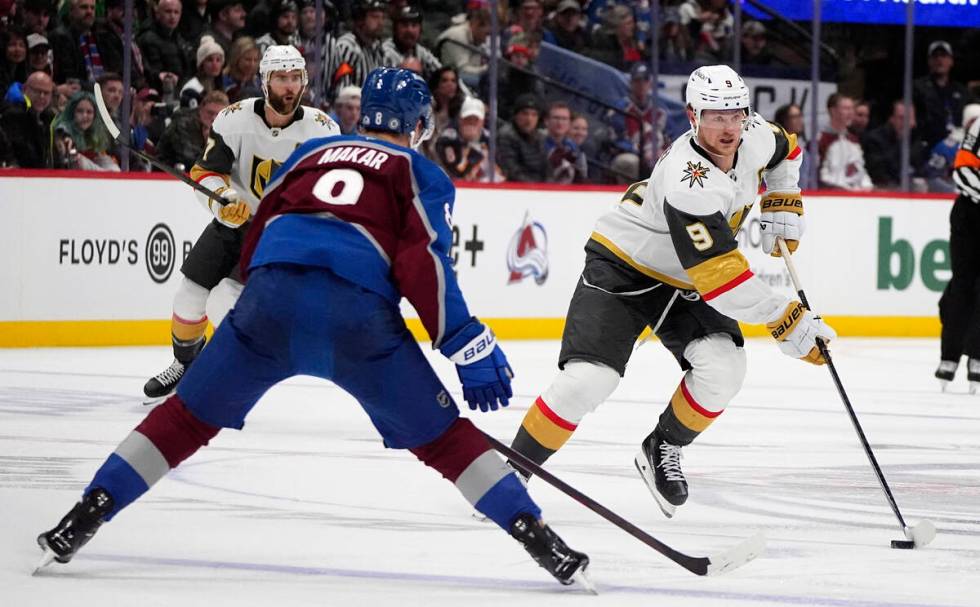 Vegas Golden Knights center Jack Eichel, right, drives down the ice with the puck as Colorado A ...