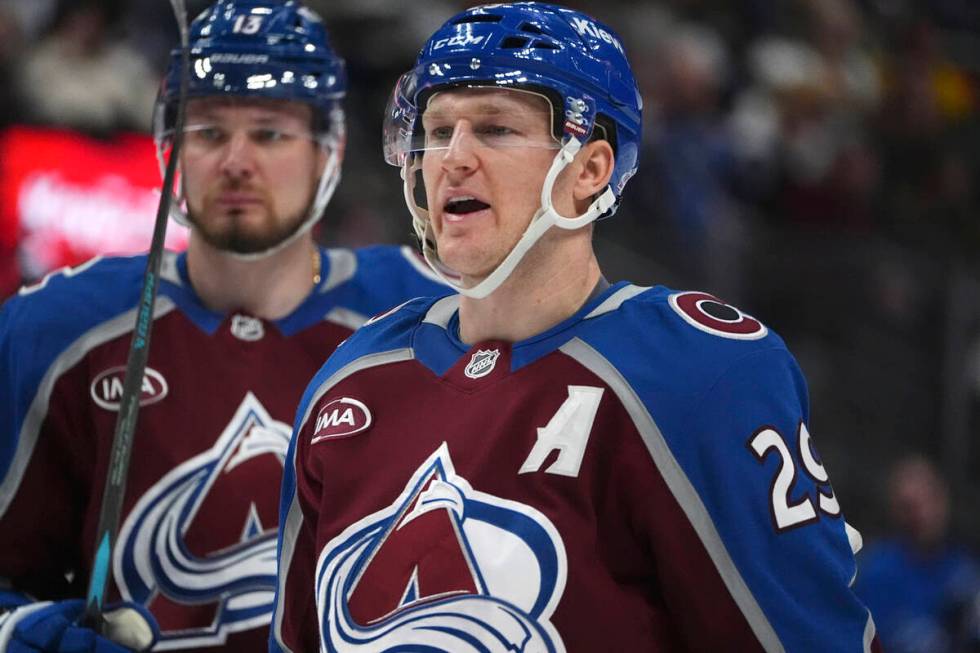 Colorado Avalanche center Nathan MacKinnon, front, argues with a referee as right wing Valeri N ...