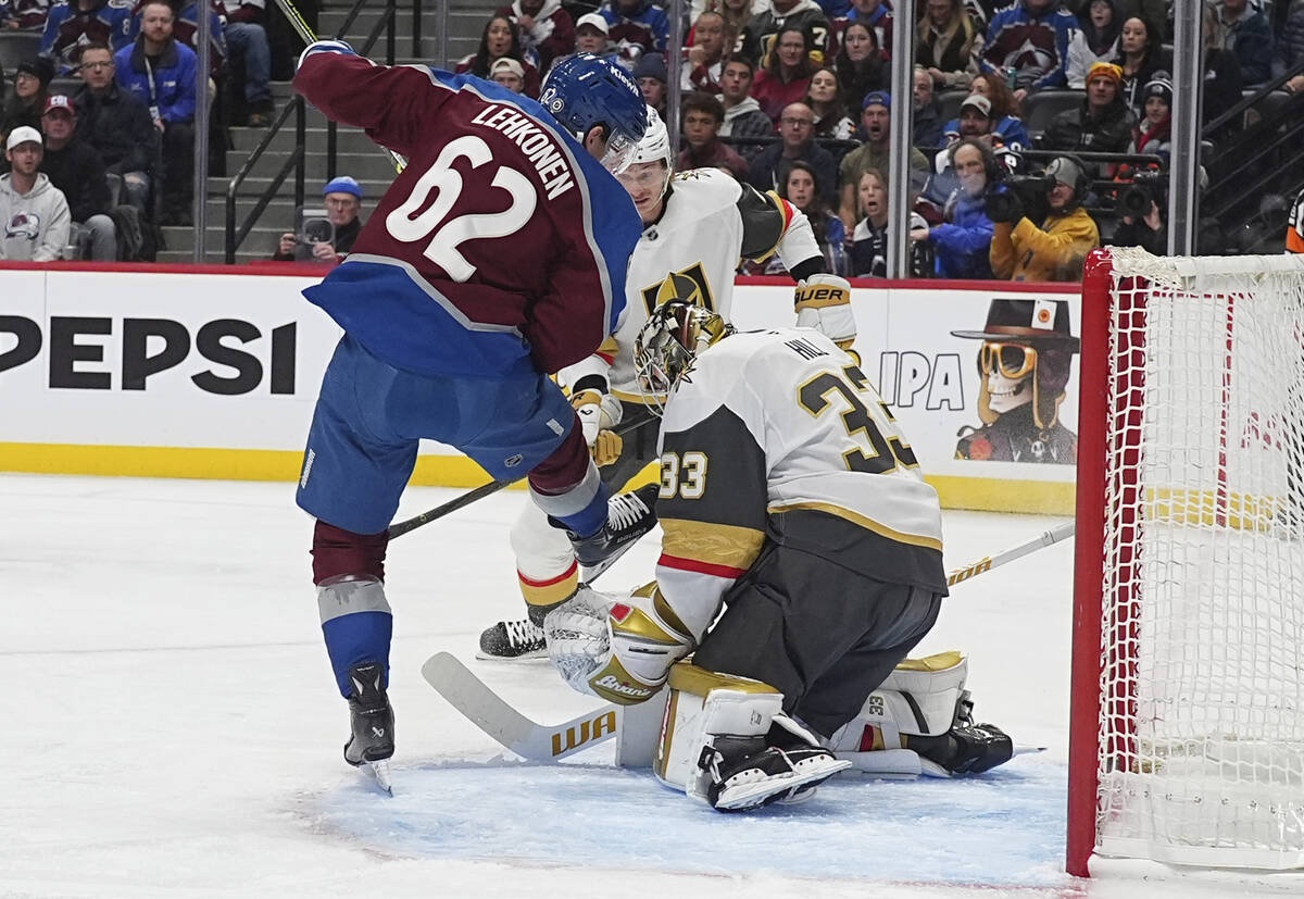 Vegas Golden Knights goaltender Adin Hill, right, makes a save of a redirected shot off the sti ...