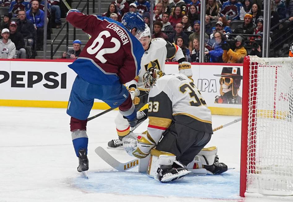 Vegas Golden Knights goaltender Adin Hill, right, makes a save of a redirected shot off the sti ...