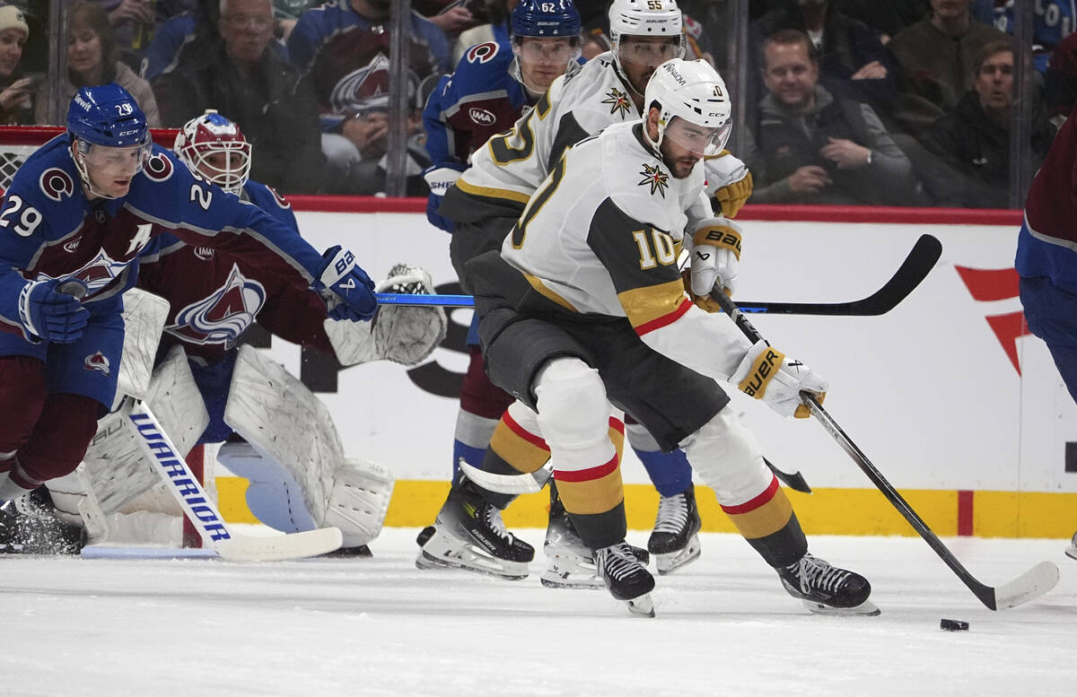 Vegas Golden Knights center Nicolas Roy, right, collects the puck as Colorado Avalanche center ...