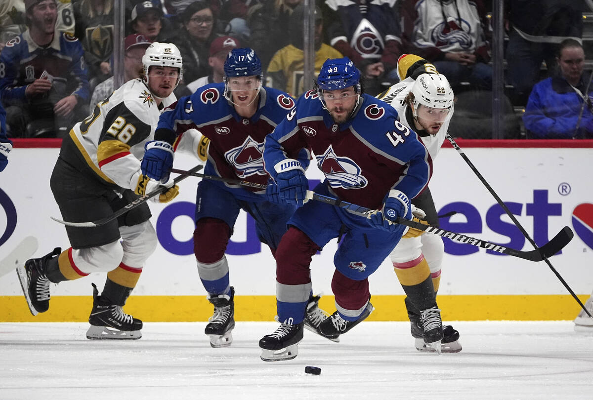 Colorado Avalanche defenseman Samuel Girard, front, collects the puck as, from back left, Vegas ...