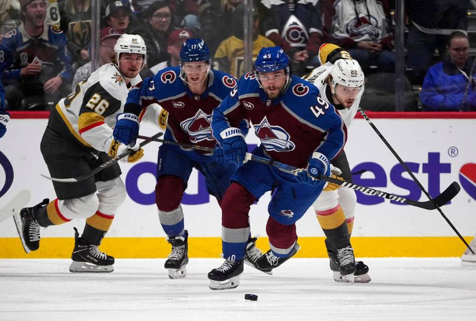 Colorado Avalanche defenseman Samuel Girard, front, collects the puck as, from back left, Vegas ...