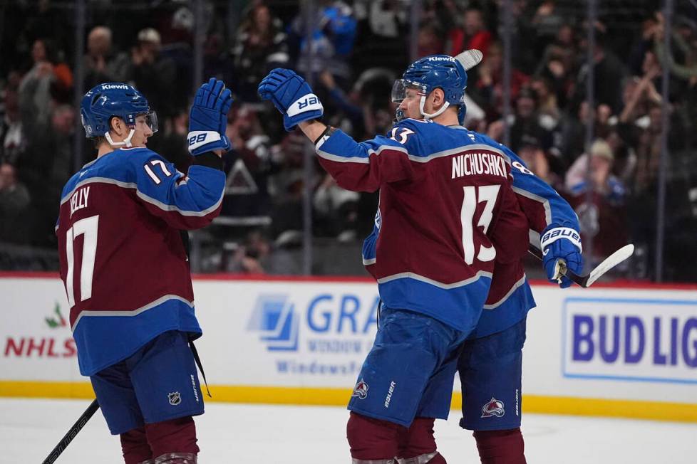 Colorado Avalanche center Parker Kelly, left, congratulates right wing Valeri Nichushkin after ...