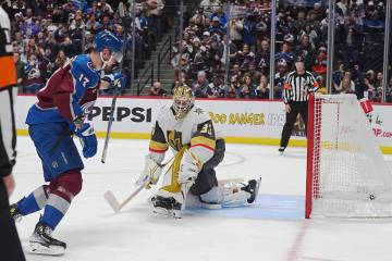 Colorado Avalanche right wing Valeri Nichushkin, left, raises his stick after scoring the winni ...