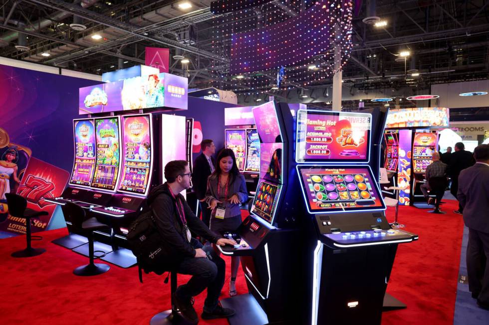 Conventioneers check out the Bravo Games booth at Global Gaming Expo at The Venetian in Las Veg ...