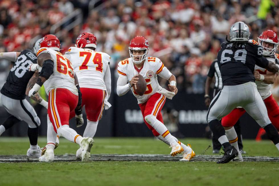 Kansas City Chiefs quarterback Patrick Mahomes (15) rushes out of the pocket against the Raider ...