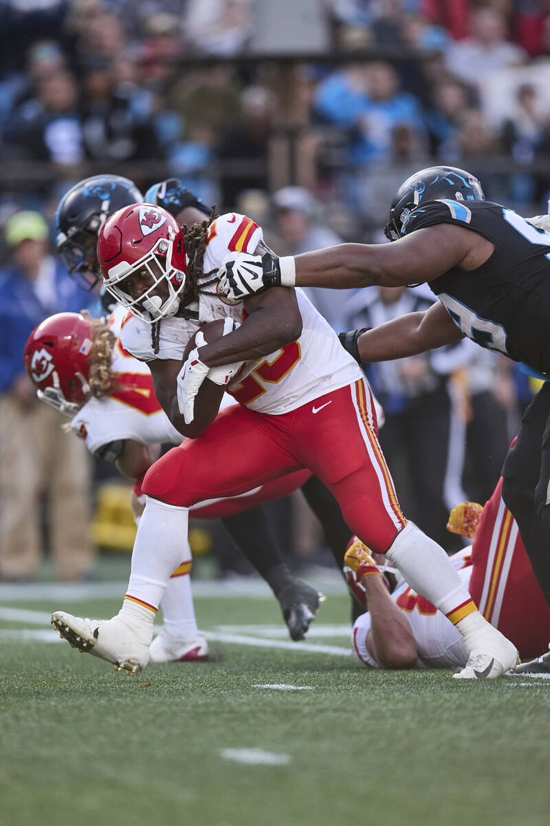 Kansas City Chiefs running back Kareem Hunt (29) runs through the tackle attempt of Carolina Pa ...