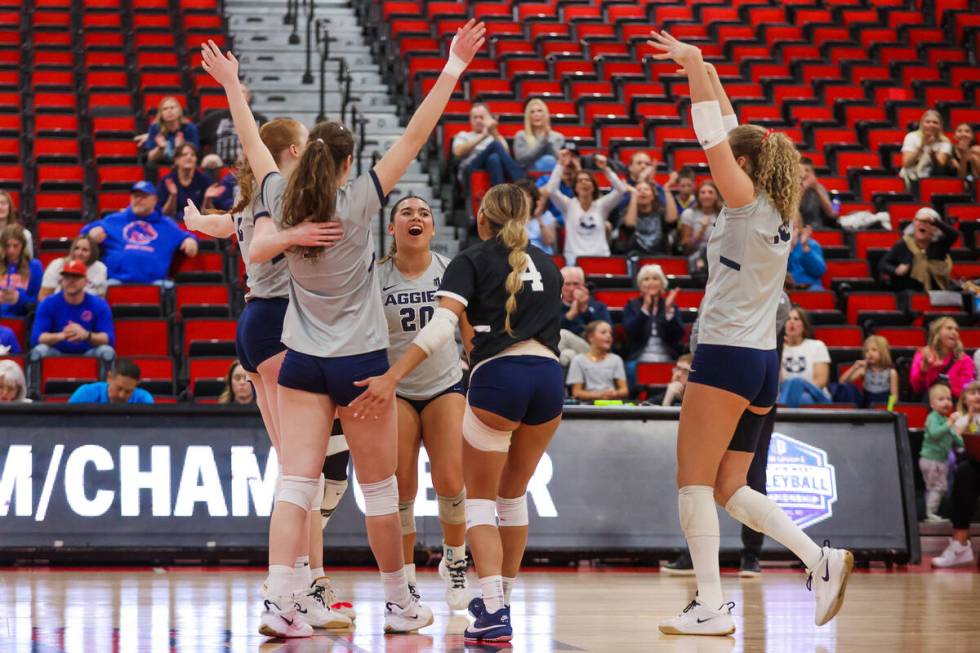 Utah State teammates celebrate during a first round game between the Utah State and Boise State ...