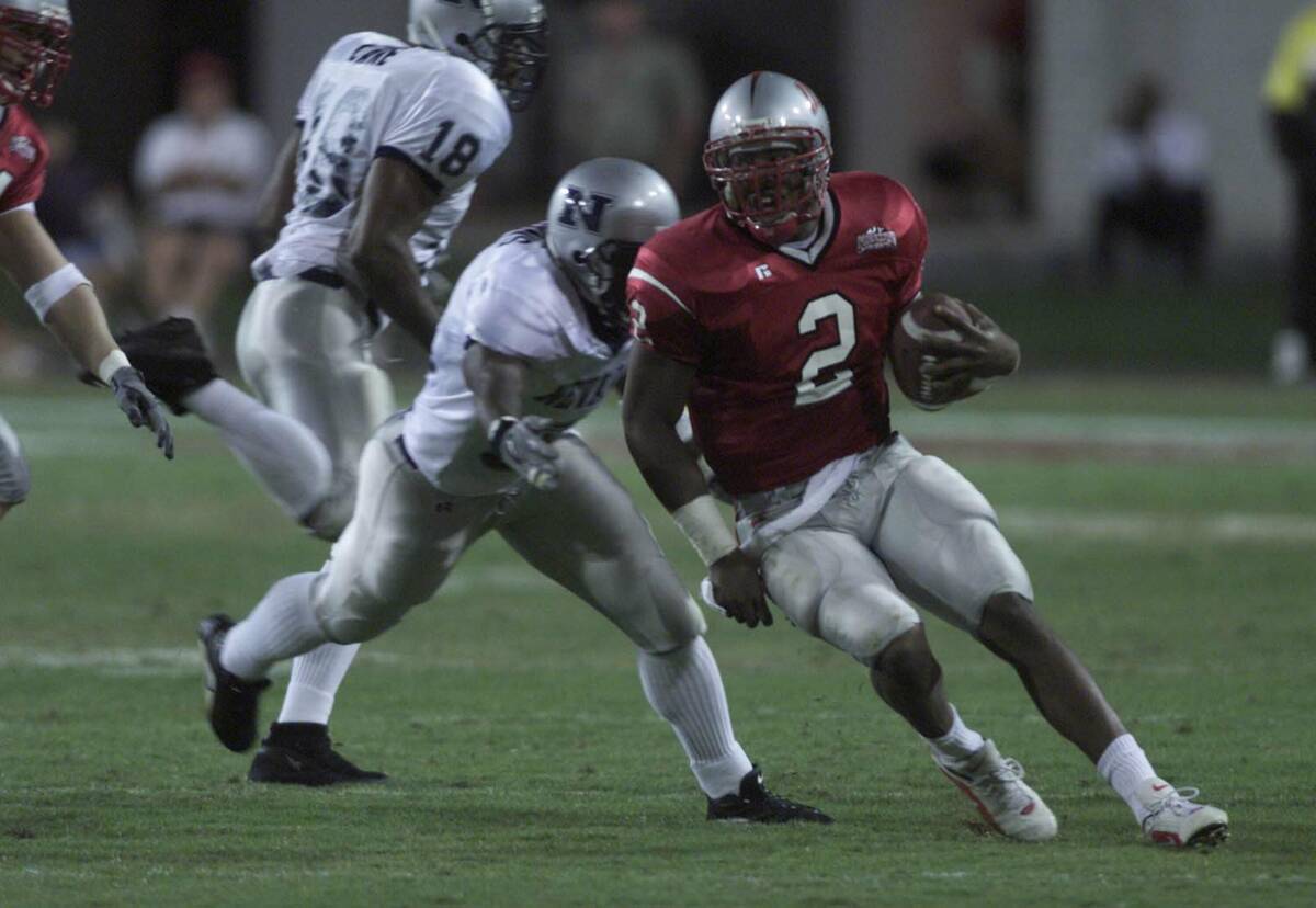 UNLV quarterback Jason Thomas runs with the ball during the second quarter against UNR on Oct. ...