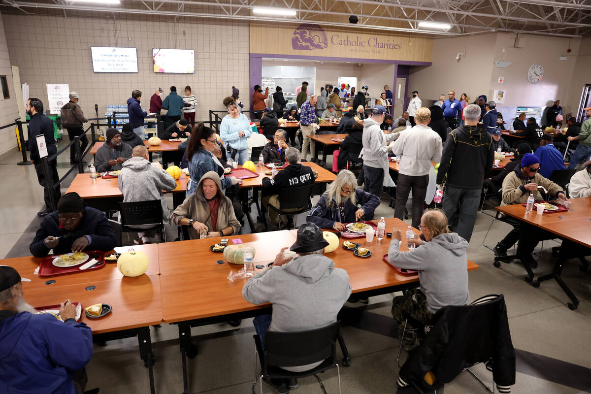 Guests eat during the Catholic Charities of Southern Nevada 59th consecutive free Thanksgiving ...