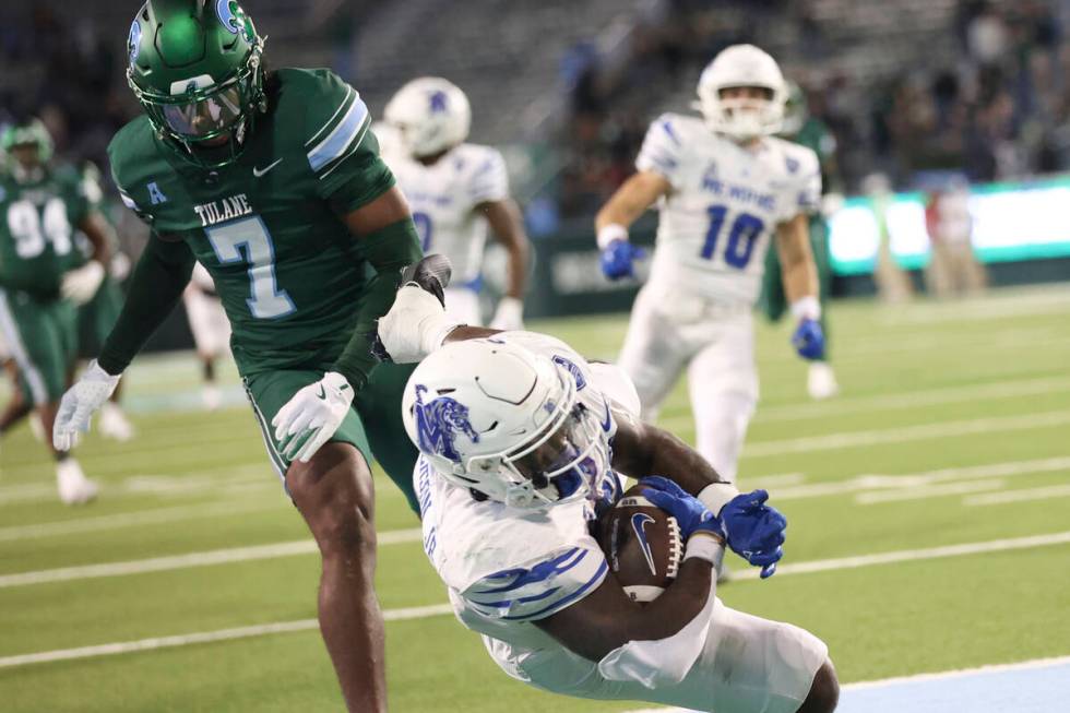 Memphis running back Mario Anderson Jr. (2) dives past Tulane safety Caleb Ransaw (7) after sco ...