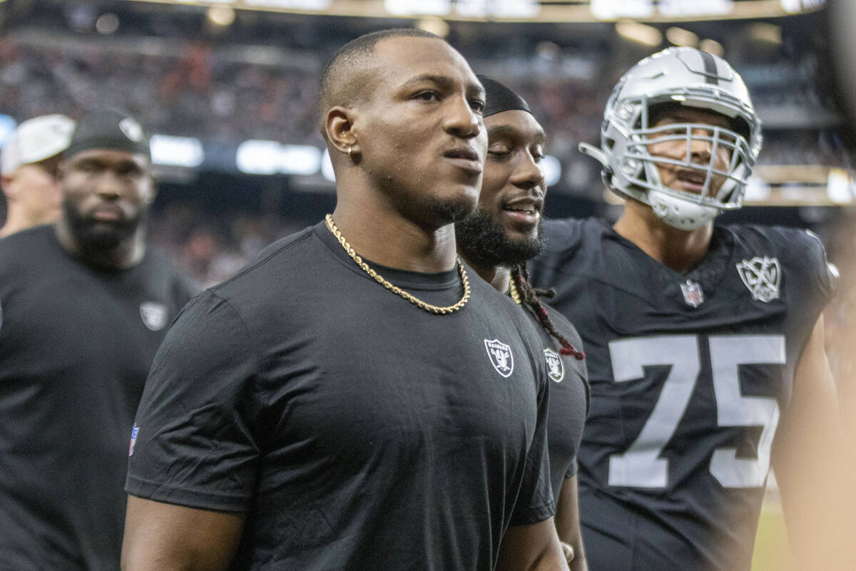 Raiders running back Zamir White, left, walks off the field for halftime of an NFL game against ...