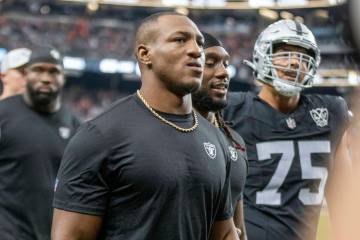 Raiders running back Zamir White, left, walks off the field for halftime of an NFL game against ...