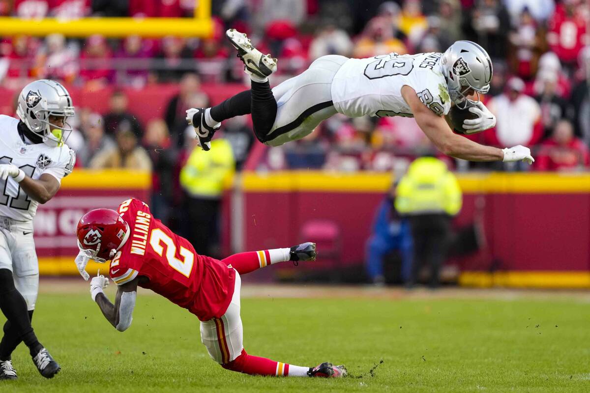 Las Vegas Raiders tight end Brock Bowers (89) tries to leap over Kansas City Chiefs cornerback ...