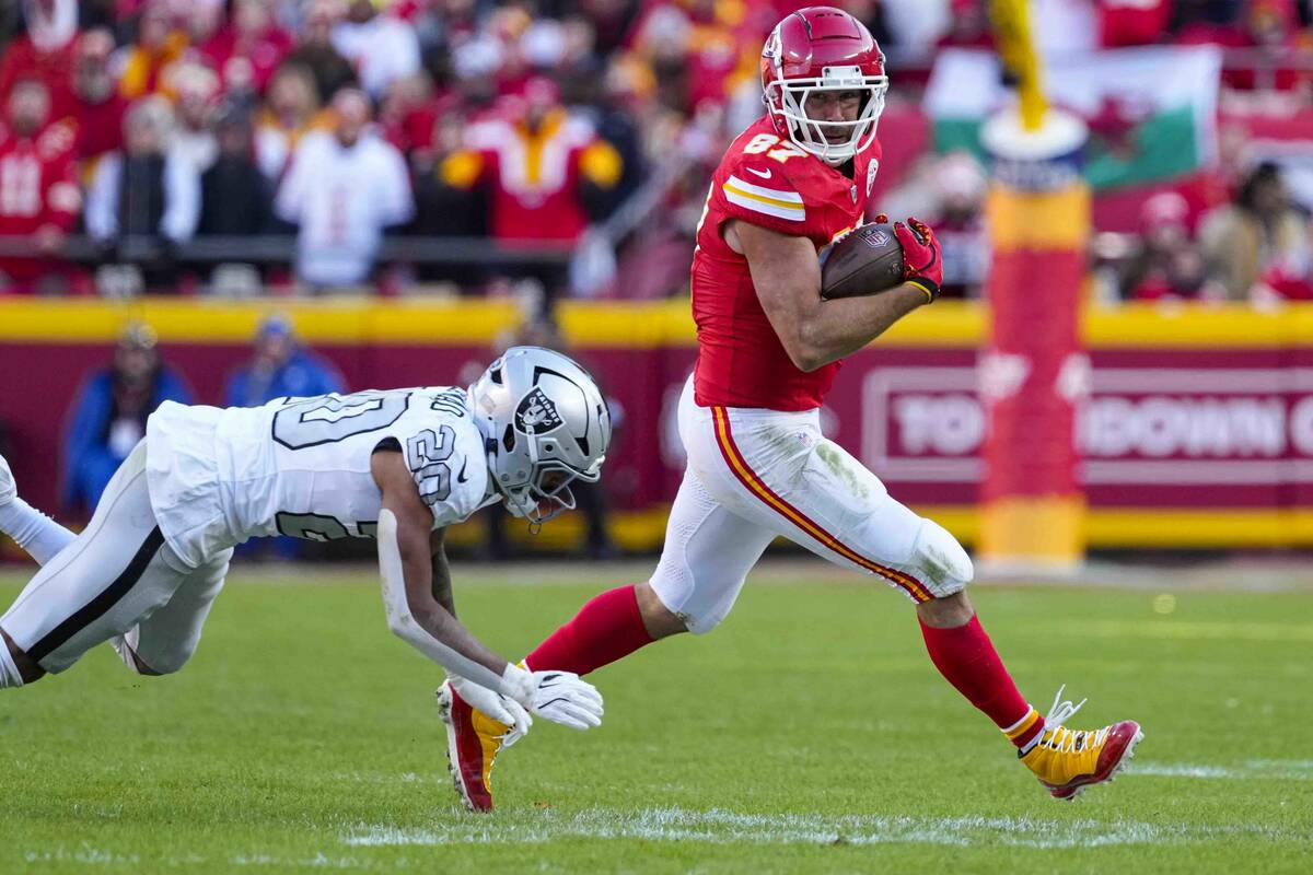 Kansas City Chiefs tight end Travis Kelce (87) outruns the tackle of Las Vegas Raiders safety I ...