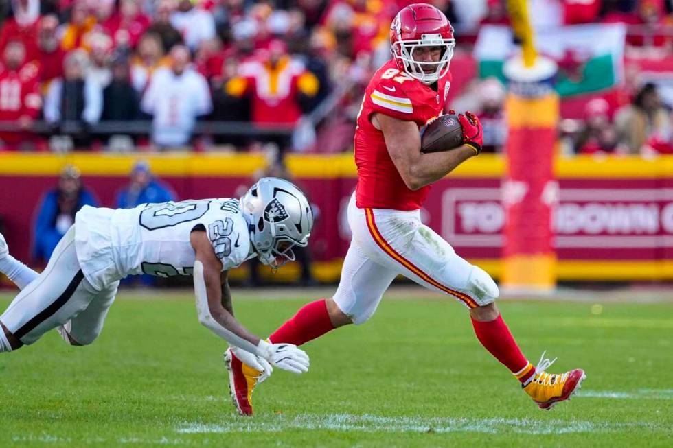 Kansas City Chiefs tight end Travis Kelce (87) outruns the tackle of Las Vegas Raiders safety I ...