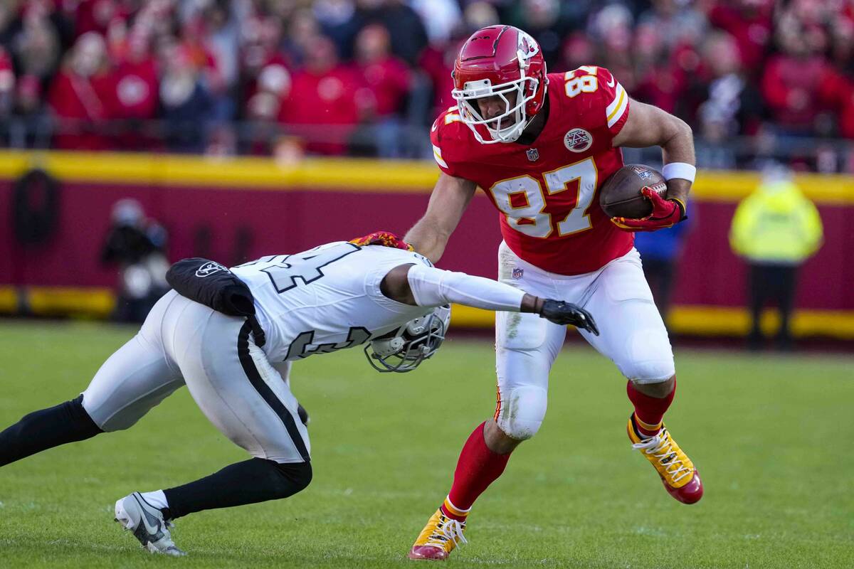 Kansas City Chiefs tight end Travis Kelce (87) pushes off the tackle of Las Vegas Raiders safet ...