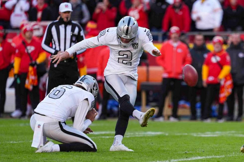 Las Vegas Raiders place kicker Daniel Carlson (2) kicks a field goal from the hold of AJ Cole a ...