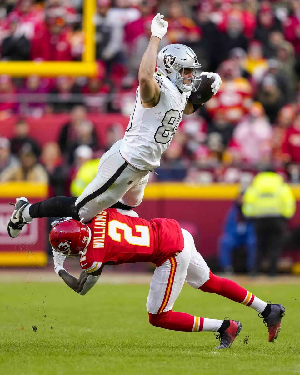 Las Vegas Raiders tight end Brock Bowers (89) tries to leap over Kansas City Chiefs cornerback ...