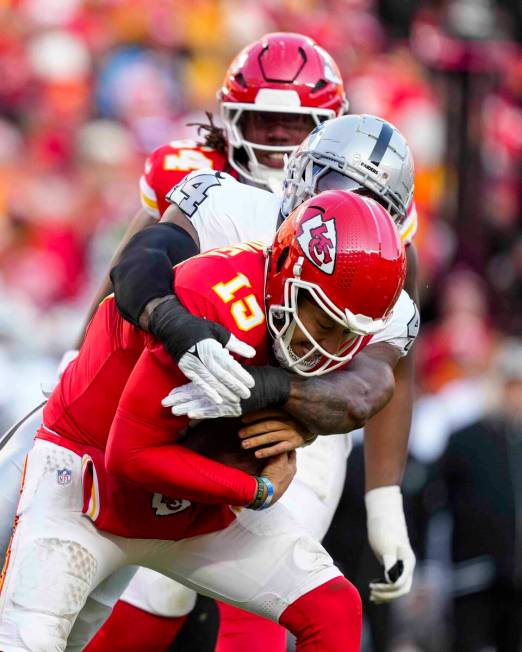 Kansas City Chiefs quarterback Patrick Mahomes (15) is sacked by Las Vegas Raiders defensive en ...