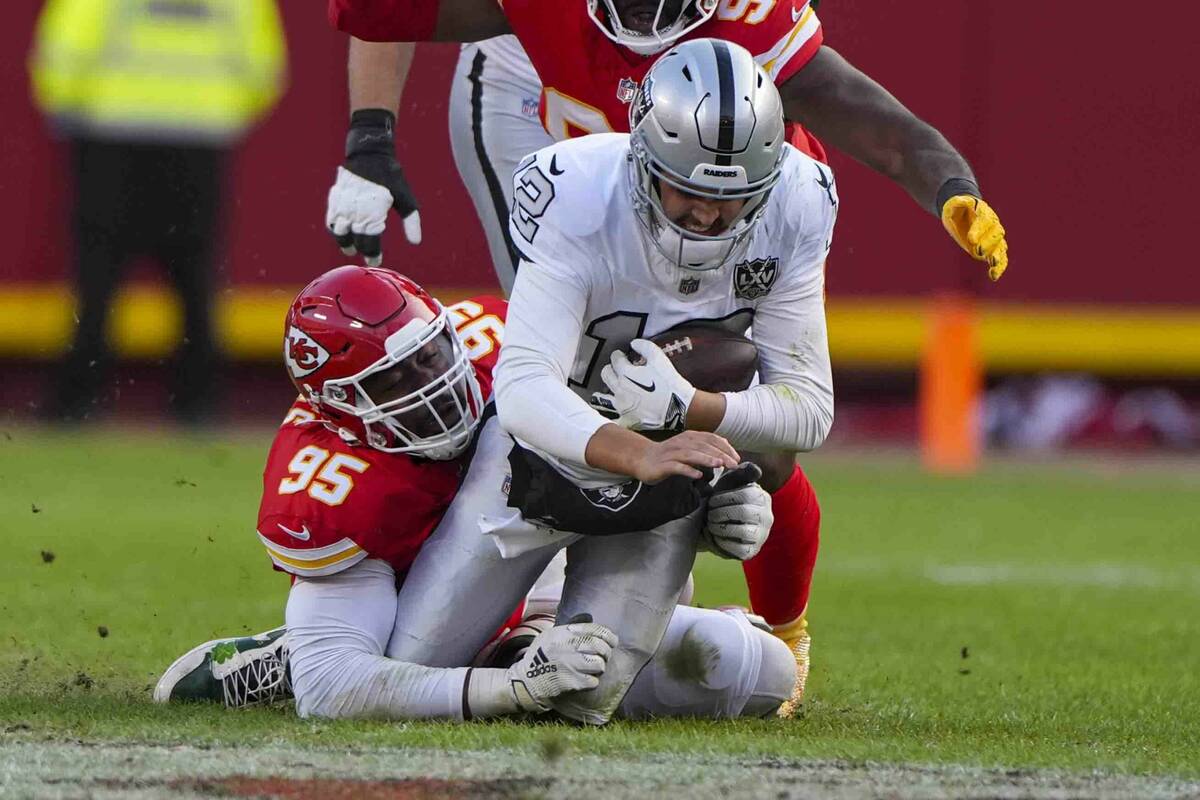 Las Vegas Raiders quarterback Aidan O'Connell (12) is sacked by Kansas City Chiefs defensive ta ...