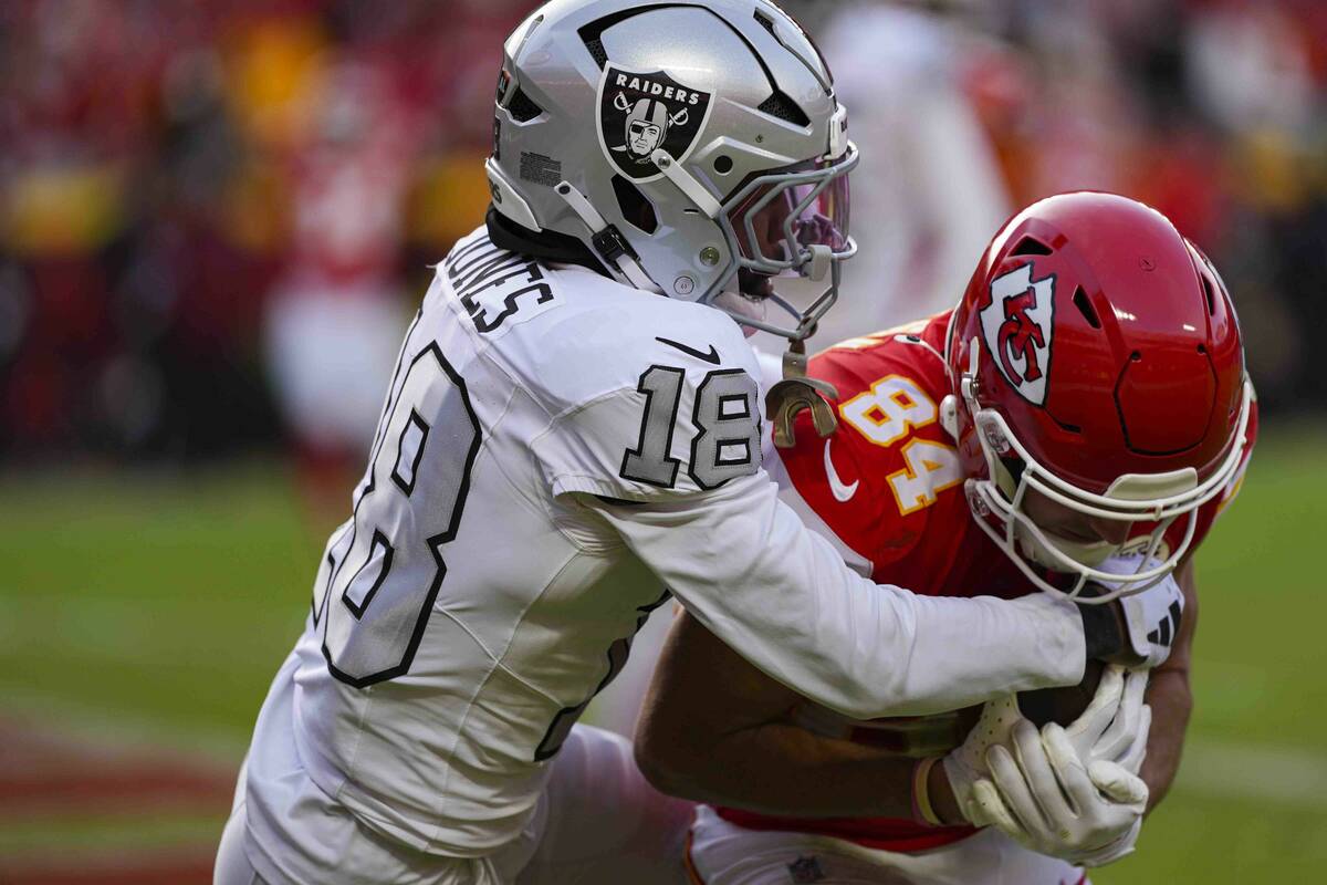 Kansas City Chiefs wide receiver Justin Watson (84) is hit by Las Vegas Raiders cornerback Jack ...