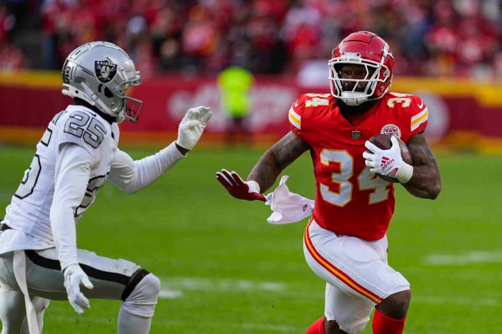 Kansas City Chiefs running back Samaje Perine (34) runs past Las Vegas Raiders cornerback Decam ...