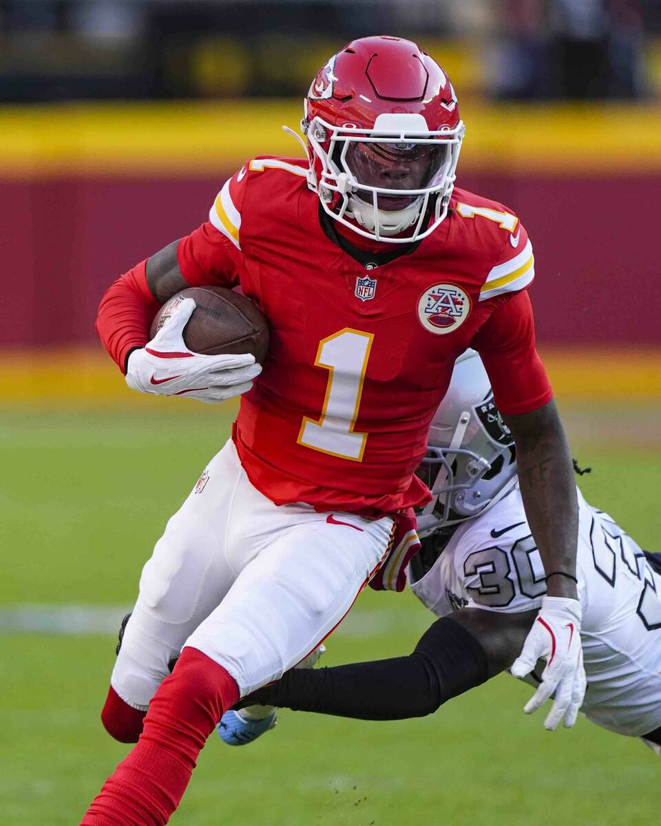 Kansas City Chiefs wide receiver Xavier Worthy (1) is tackled by Las Vegas Raiders cornerback D ...