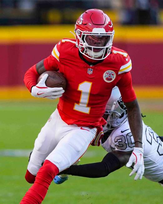 Kansas City Chiefs wide receiver Xavier Worthy (1) is tackled by Las Vegas Raiders cornerback D ...