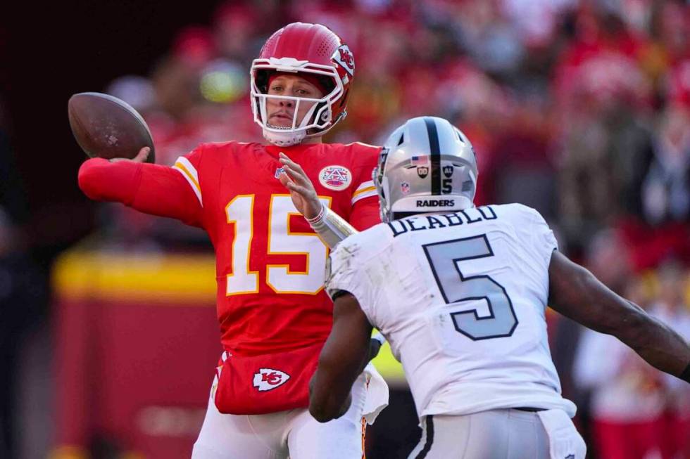 Kansas City Chiefs quarterback Patrick Mahomes (15) throws over Las Vegas Raiders linebacker Di ...