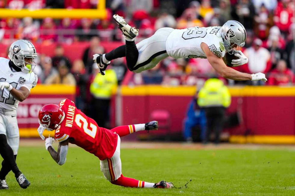 Las Vegas Raiders tight end Brock Bowers (89) tries to leap over Kansas City Chiefs cornerback ...