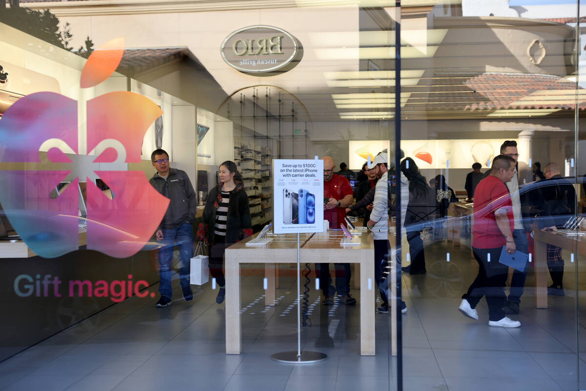 People shop at the Apple Store at Town Square in Las Vegas on Black Friday, Nov. 29, 2024. (K.M ...