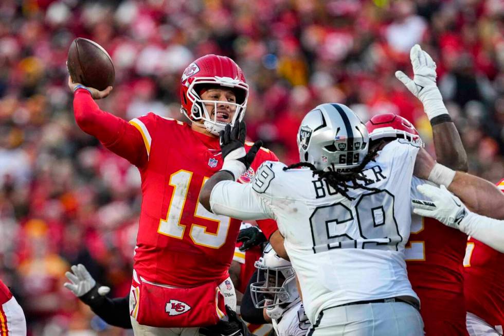 Kansas City Chiefs quarterback Patrick Mahomes (15) throws over Las Vegas Raiders defensive tac ...